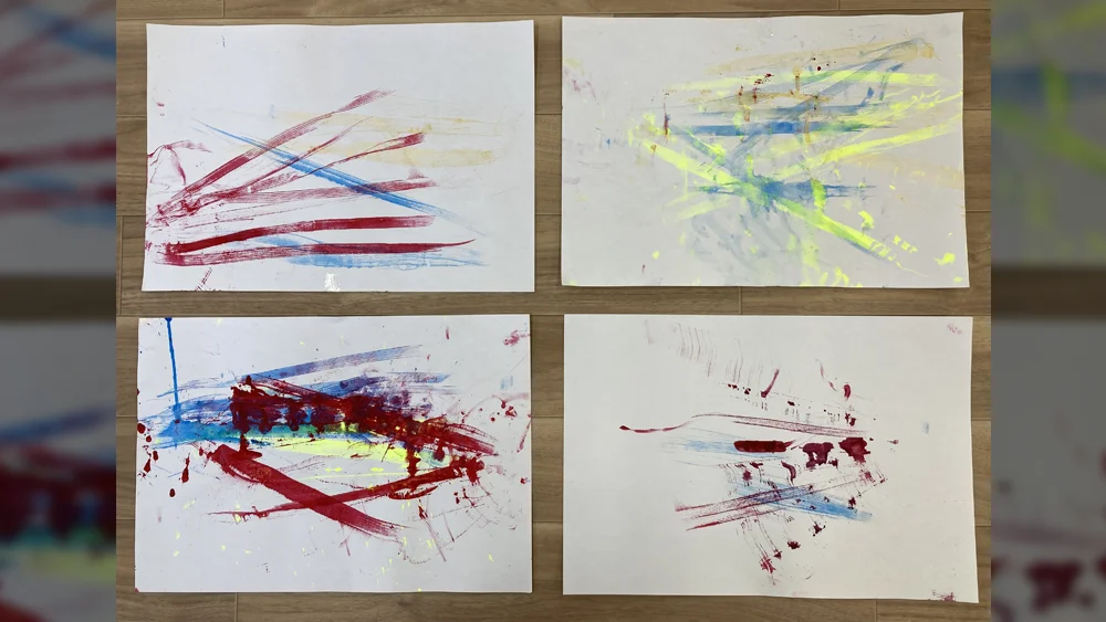 白い画用紙いっぱいに描かれた、生き生きとした色づかいが目を引くこどもたちのカラフルな絵